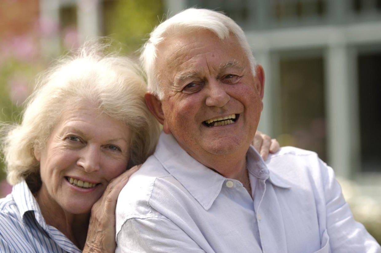 A smiling older couple outdoors